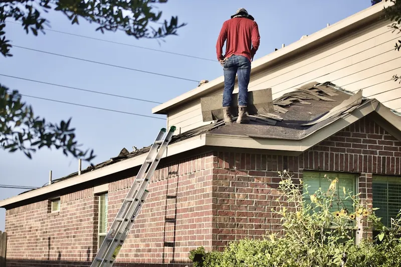 Professional roofer working on a residential roof in Corwin